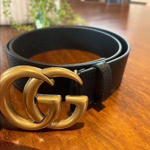 Wide leather Gucci belt with double G buckle.